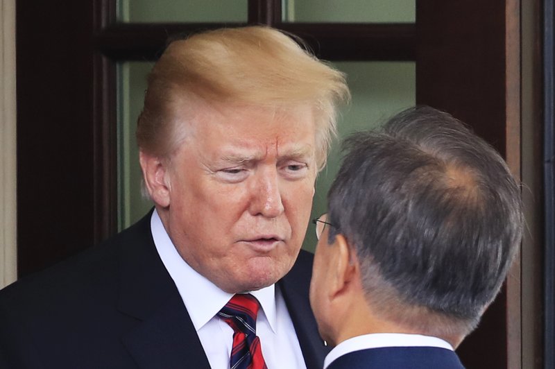 President Donald Trump talks to visiting South Korean President Moon Jae-in as he departs the White House in Washington, Tuesday, May 22, 2018. (AP Photo/Manuel Balce Ceneta)

