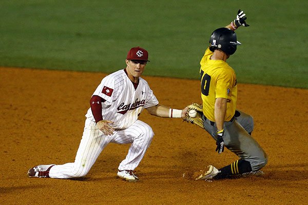 Missouri's Matt Berler (10) beats the tag from South Carolina infielder Justin Row as he slides into second base during the fifth inning of a Southeastern Conference tournament NCAA college baseball game Tuesday, May 22, 2018, in Hoover, Ala. (AP Photo/Butch Dill)

