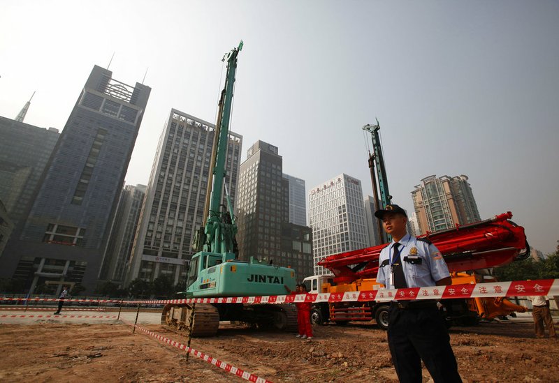 FILE - In this Oct. 26, 2009 file photo, security workers guard at construction site of the U.S. Consulate compound in Guangzhou in southern China's Guangdong province. The State Department said an email notice Wednesday, May 23, 2018, that a U.S. government employee in southern China reported abnormal sensations of sound and pressure, recalling similar experiences among American diplomats in Cuba who later fell ill. (Chinatopix via AP, File)