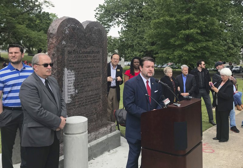 In this April 26 file photo, Arkansas Republican state Sen. Jason Rapert speaks at the unveiling of a Ten Commandments monument outside the Arkansas state Capitol in Little Rock. Opponents of the display filed lawsuits Wednesday to have the monument removed, arguing it's an unconstitutional endorsement of religion by government. A 2015 law required the state to allow the privately funded monument. (AP Photo/Andrew DeMillo, File)
