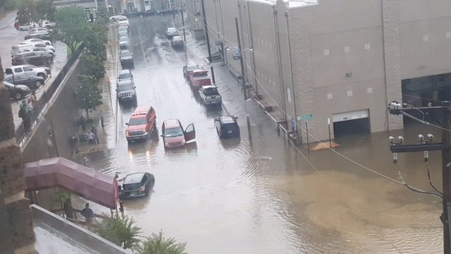 Vehicles drive through a flooded intersection in the area of Markham and Woodlane streets Wednesday, May 23, 2018.