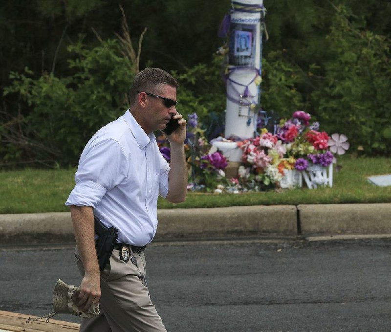 Little Rock Police Capt. Russell King passes a memorial for Ebby Steppach as he works Tuesday at Chalamont Park in west Little Rock. 