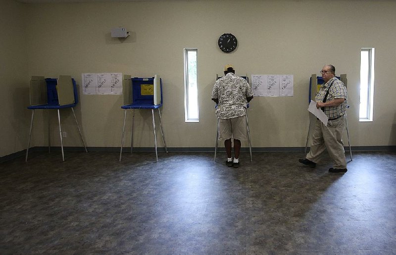 Arkansas Democrat-Gazette/THOMAS METTHE -- 5/22/2018 --
Voter Melvin Withers (left) of Woodson fills out his ballot as Charles Walderns (right) of Woodson leaves the voting booth during the primary election on Tuesday, May 22, 2018, at New Haven United Methodist Church in Hensley. 