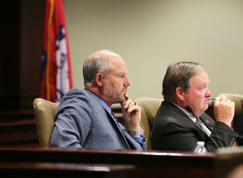 Republicans Sen. Jim Hendren of Sulphur Springs and Rep. Lane Jean of Magnolia listen to speakers Wednesday during a meeting of the task force that’s reviewing the state tax code.  