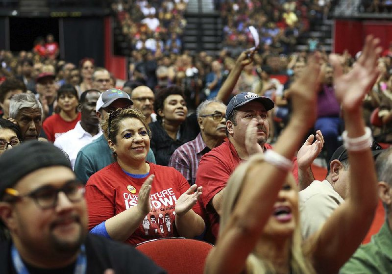 Members of the Culinary Workers Union, Local 226, in Las Vegas applaud during a presentation Tuesday before voting to authorize a strike.  