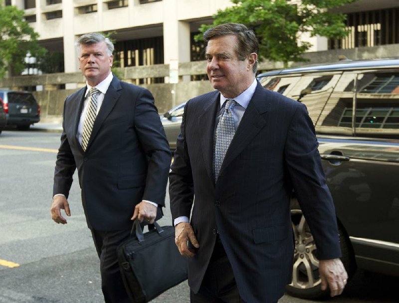 Paul Manafort (right), President Donald Trump’s former campaign chairman, arrives Wednesday at Federal District Court in Washington with his attorney, Kevin Downing.  