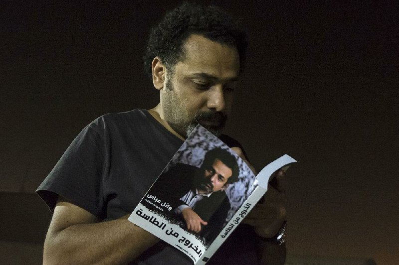 Egyptian activist Wael Abbas, shown last summer signing his book, The Theory of Leaving the Bowl, was arrested at his home Wednesday, accused of disseminating false news.  