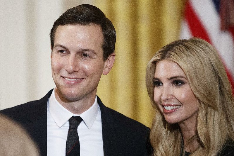 White House Senior Adviser Jared Kushner and his wife, Ivanka Trump, take part in a White House event Friday. Kushner’s FBI background checks dragged on for a year before he was finally cleared in recent days.  