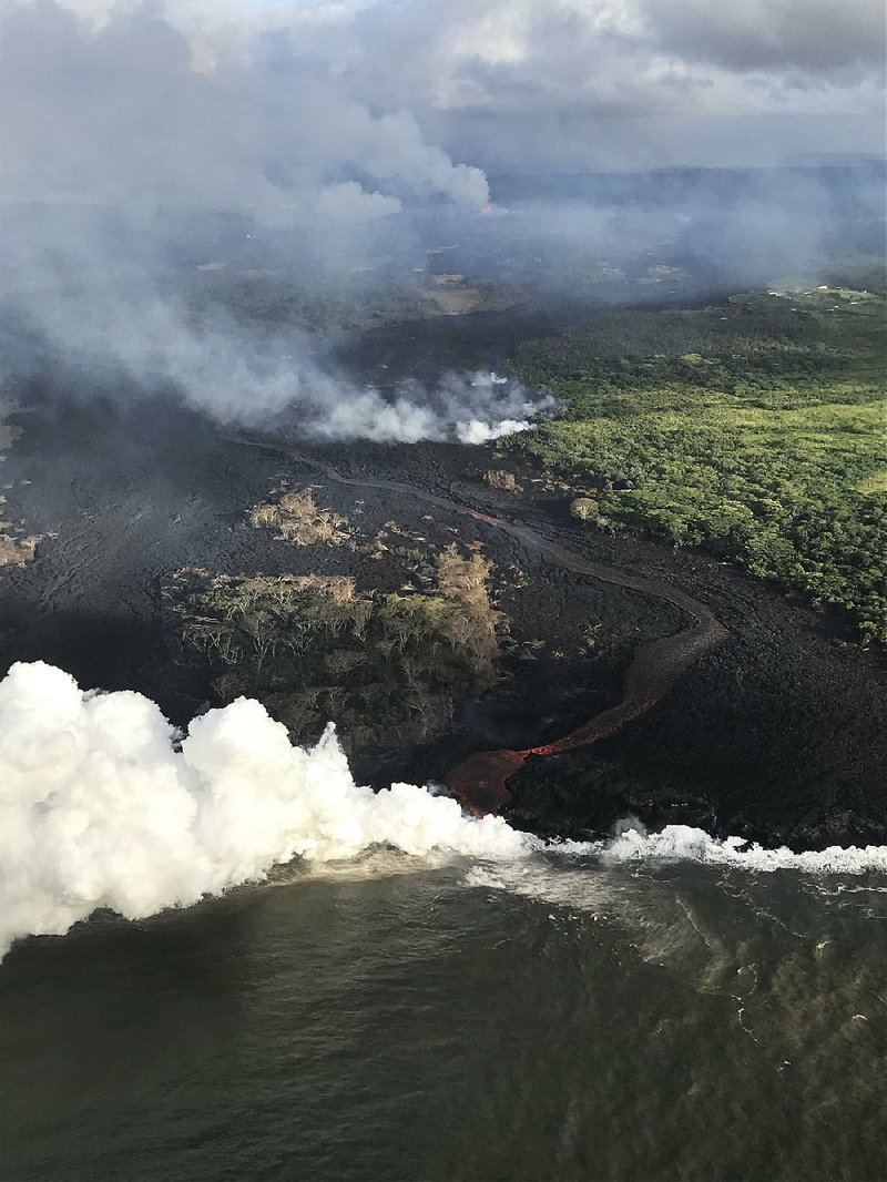 Lava from the Kilauea volcano pours into the ocean Wednesday near Pahoa, Hawaii. 