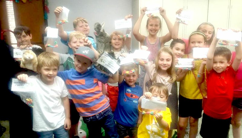 Courtesy photo A group of youngsters enjoy their success in completing a Cookie BOOKie Club program. The readers finished Stone Fox and celebrated with a book worm party.