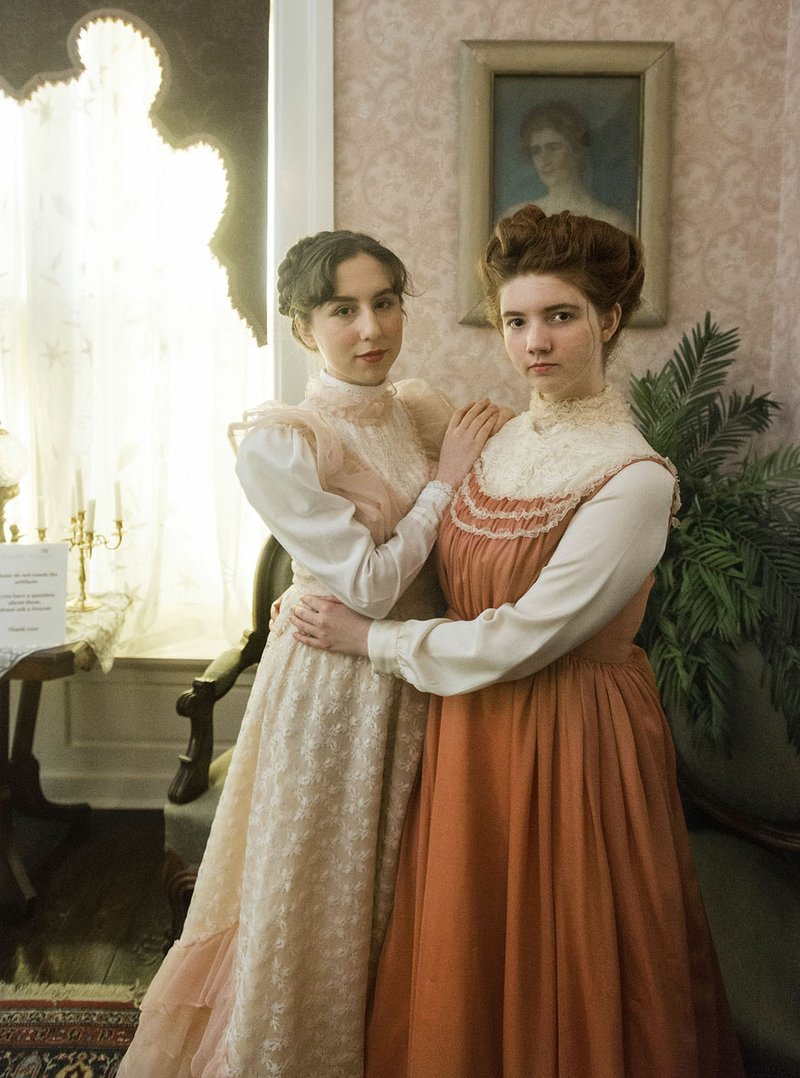 FILE PHOTO/BEN GOFF @NWABENGOFF Oryah Rudick (left), in costume as Katherine Peel, and Sarah Goble, in costume as Mary Emaline Berry Peel, pose for a photo recently at the Peel Mansion Museum and Heritage Gardens in Bentonville. Proceeds from today's "Sharing Spirits" benefit at the mansion and garden will help support museum programs.