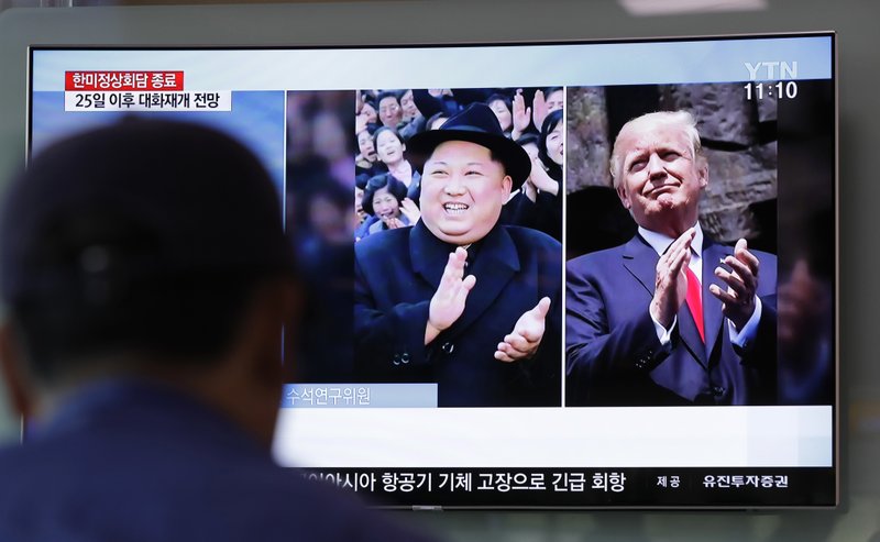 A man watches a TV screen showing file footage of U.S. President Donald Trump, right, and North Korean leader Kim Jong Un, left, during a news program at the Seoul Railway Station in Seoul, South Korea, Wednesday, May 23, 2018.  (AP Photo/Lee Jin-man)