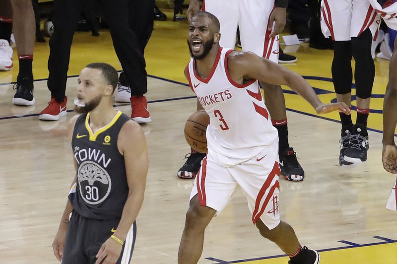 The Associated Press ROCKETING BACK: Houston Rockets guard Chris Paul (3) celebrates next to Golden State Warriors guard Stephen Curry (30) during the second half of Game 4 of the NBA Western Conference Finals in Oakland, Calif., Tuesday.