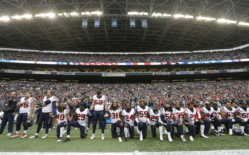 The Associated Press NFL BANS KNEELING: Houston Texans players kneel and stand during the singing of the national anthem on Oct. 29, 2017, before an NFL game against the Seattle Seahawks, in Seattle. NFL owners have approved a new policy aimed at addressing the firestorm over national anthem protests, permitting players to stay in the locker room during the "The Star-Spangled Banner" but requiring them to stand if they come to the field. The decision was announced Wednesday by NFL Commissioner Roger Goodell during the league's spring meeting in Atlanta.