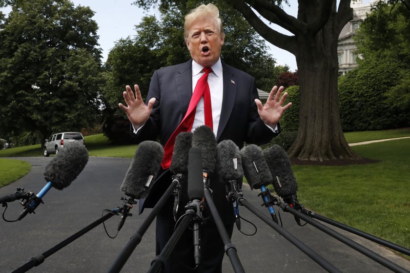 President Donald Trump's hair is ruffled by a breeze as he speaks to the media on the South Lawn of the White House in Washington, Wednesday, May 23, 2018, en route to a day trip to New York.  (AP Photo/Jacquelyn Martin)