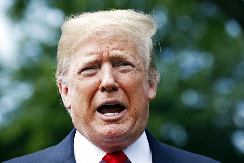 In this May 23, 2018, photo, President Donald Trump speaks to the media before boarding the Marine One helicopter on the South Lawn of the White House in Washington. Two House lawmakers who are allies of President Donald Trump are set to meet with top intelligence officials Thursday as Trump has raised new suspicions about the federal investigation that is looking into his campaign. (AP Photo/Jacquelyn Martin)