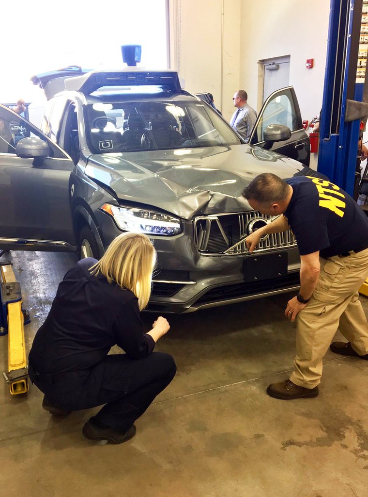 FILE- In this March 20, 2018, file photo provided by the National Transportation Safety Board, investigators examine a driverless Uber SUV that fatally struck a woman in Tempe, Ariz. In a preliminary report on the crash released Thursday, May 24, federal investigators said the autonomous Uber SUV that struck and killed an Arizona pedestrian in March spotted the woman about six seconds before hitting her, but didn’t stop automatically because emergency braking was disabled. (National Transportation Safety Board via AP, File)