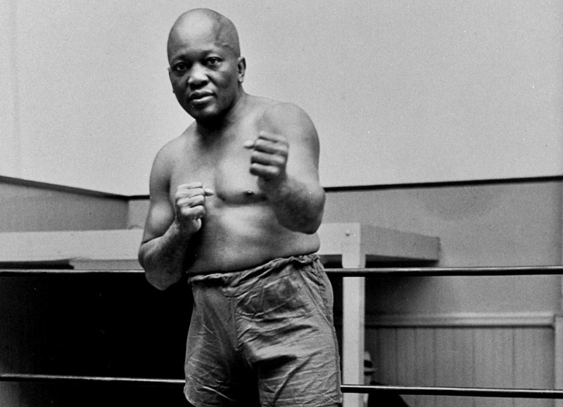 In this 1932 file photo, boxer Jack Johnson, the first black world heavyweight champion, poses in New York City.