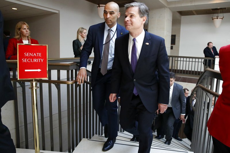 FBI Director Christopher Wray, right, leaves a classified briefing about the federal investigation into President Donald Trump's 2016 campaign on Capitol Hill in Washington on Thursday, May 24, 2018.