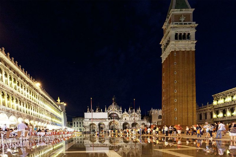 Nighttime on St. Mark’s Square comes with ambience-filled cafes, dueling orchestras, and sometimes some atmospheric flooding. 
