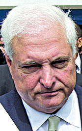 In this Jan. 2, 2014 file photo, Panama's then President Ricardo Martinelli, center, leaves Congress after delivering his last State of the Nation address, in Panama City.