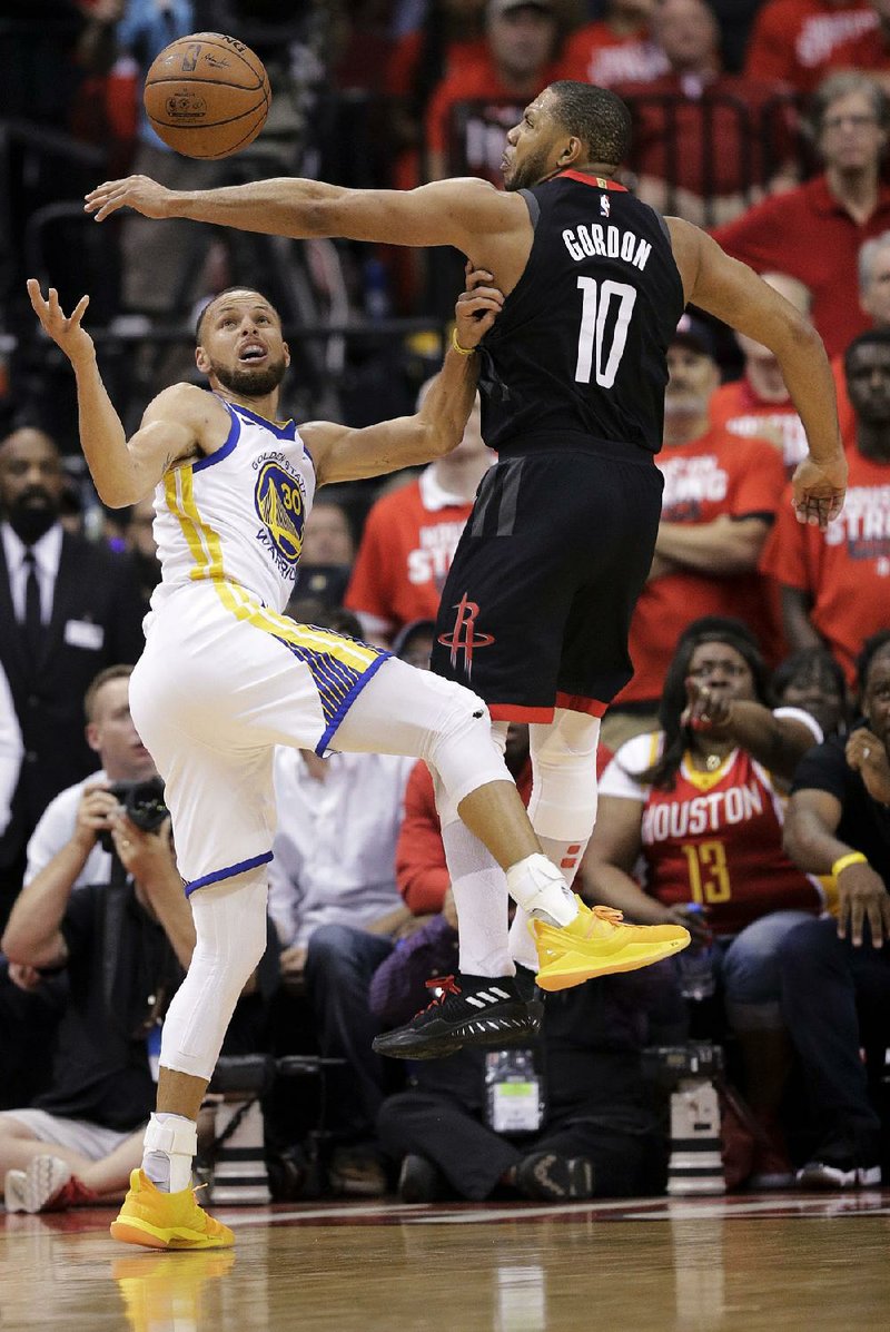 Houston guard Eric Gordon (right) blocks a shot by Golden State guard Stephen Curry during the second half of the Rockets’ 98-94 victory over the Warriors on Thursday in Game 5 of the NBA’s Western Conference final in Houston. Gordon led the Rockets with 24 points off the bench and his steal on Golden State’s final possession helped seal the victory.  
