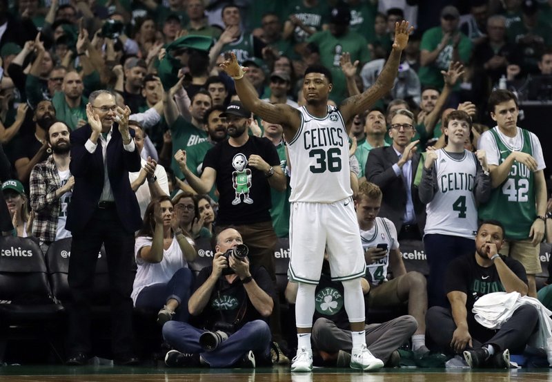 The Associated Press ONE GAME AWAY: Celtics guard Marcus Smart celebrates late in the team's 96-83 home win Wednesday in Boston in Game 5 of the NBA's Eastern Conference finals against the Cleveland Cavaliers.