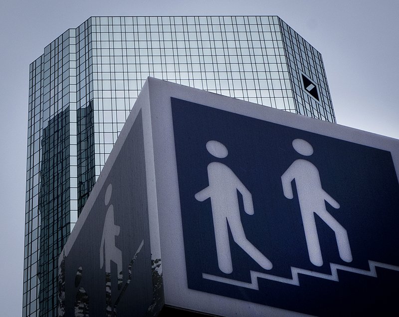 A sign for a pedestrians stand in front of the Deutsche Bank towers, on the day of the annual meeting of the bank, in Frankfurt, Germany, Thursday, May 24, 2018.(AP Photo/Michael Probst)
