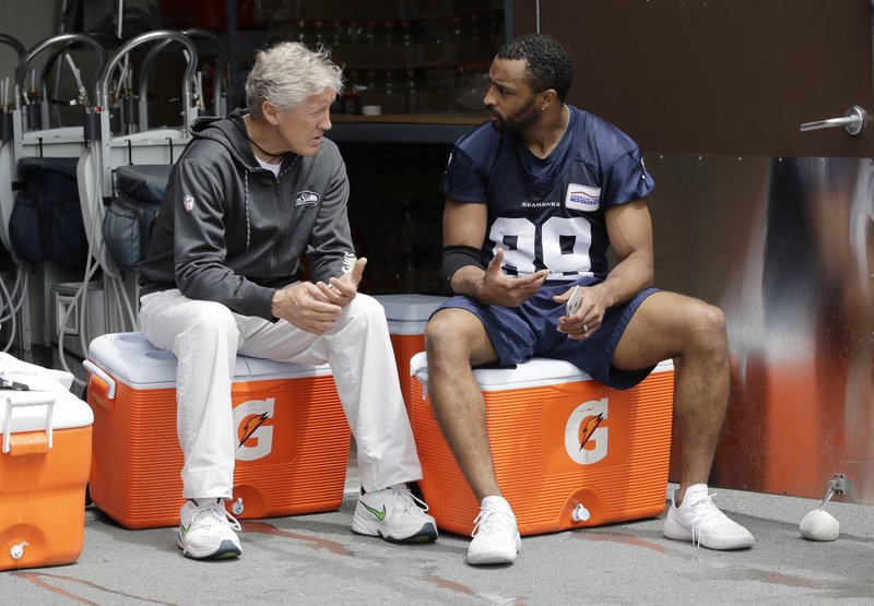 The Associated Press STRONG WORDS: Seattle Seahawks wide receiver Doug Baldwin, right, talks with head coach Pete Carroll following NFL practice Thursday in Renton, Wash.