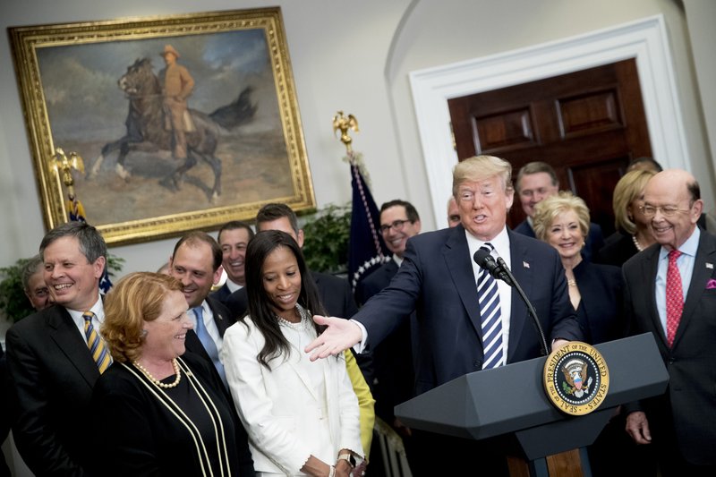 President Trump, center right, speaks before signing into law a bill that rolls back banking regulations on May 24, 2018. MUST CREDIT: Bloomberg photo by Andrew Harrer