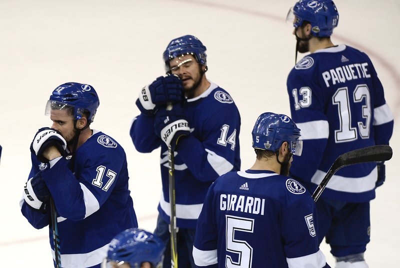 Tampa Bay Lightning's Alex Killorn (17), Chris Kunitz (14), Dan Girardi (5) and Cedric Paquette (13) watch the Washington Capitals celebrate a 4-0 win in Game 7 of the NHL Eastern Conference finals hockey playoff series Wednesday, May 23, 2018, in Tampa, Fla. (AP Photo/Jason Behnken)