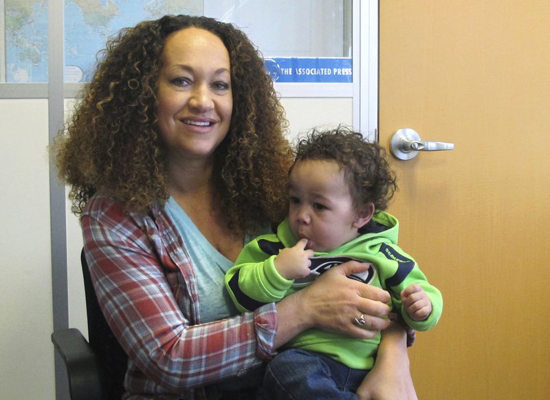 FILE - In this March 20, 2017, file photo, Rachel Dolezal poses for a photo with her son, Langston, at the bureau of The Associated Press in Spokane, Wash. Dolezal, a former NAACP leader in Washington state whose life unraveled after she was outed as a white woman pretending to be black, has been charged with welfare fraud, news station KHQ-TV reports Thursday, May 24, 2018. (AP Photo/Nicholas K. Geranios, File)

