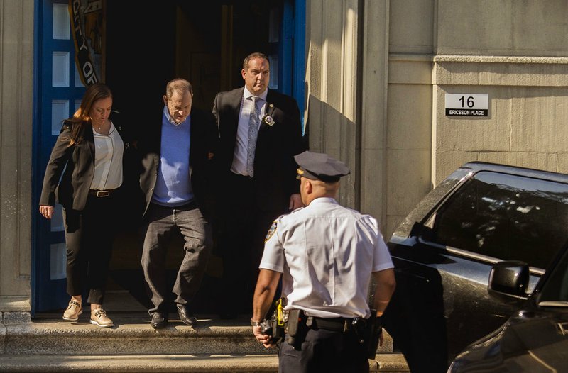 Harvey Weinstein, second left, is escorted into an unmarked vehicle while leaving the first precinct of the New York City Police Department after turning himself to authorities following allegations of sexual misconduct, Friday, May 25, 2018, in New York. (APPhoto/Andres Kudacki)