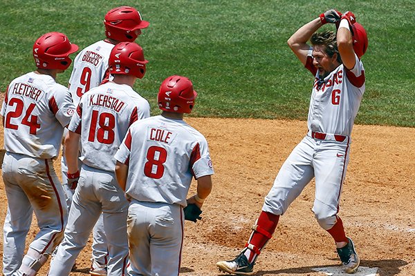Arkansas' Hunter Wilson (6) celebrates as he crosses home plate after hitting a grand slam during the ninth inning of a Southeastern Conference tournament NCAA college baseball game against Florida, Friday, May 25, 2018, in Hoover, Ala. (AP Photo/Butch Dill)


