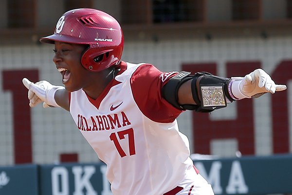 Oklahoma's Shay Knighten celebrates a home run in the third inning against Arkansas during the first game of an NCAA softball super regional in Norman, Okla., Friday, May 25, 2018. (Sarah Phipps/The Oklahoman via AP)

