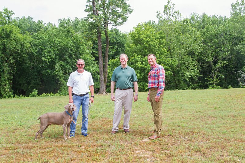 Batesville Parks and Recreation Director Jeff Owens, from left, and his dog, Mason, stand with pharmacist Steve Bryant and Mayor Rick Elumbaugh on the property adjacent to Riverside Park where the Sara Low Memorial Dog Park will be built. Girl Scout Stephannie Laslo is working on the project, too. Low, a stewardess, was killed on 9/11 when the plane she was on was the first to hit the World Trade Center. A public meeting on the dog park is scheduled for 5:30 p.m. June 21 at the Batesville Community Center.