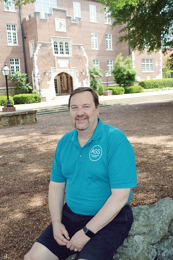 Lyle Rupert, 57, sits in the Pecan Grove at Hendrix College in Conway.  He was recently named the school’s C. Louis and Charlotte Cabe Distinguished Professor of Economics and Business. Rupert, who is serving his 13th summer with the Arkansas Governor’s School — his 12th and final as director — also received three awards this spring.