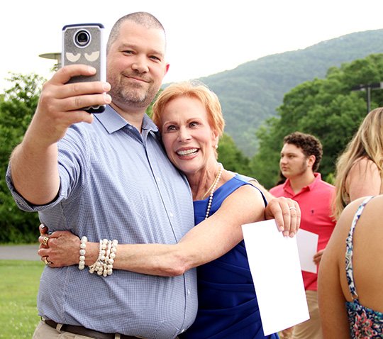 The Sentinel-Record/Beth Reed PHOTO OP: Paul McKinney, left, takes a selfie with Kerry Lockwood-Owen after a reception Tuesday for recipients of the Oaklawn Foundation Scholarship. McKinney is a former student of Lockwood-Owen’s and said he took the photo to send to his wife, Kasey, who could not attend the reception. He is pursuing a degree from Southern Arkansas University Tech.