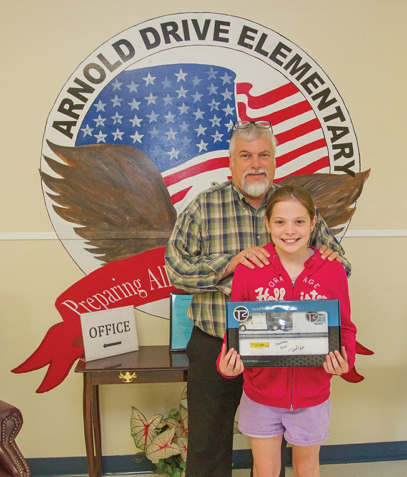 Mariah Roberts, a fifth-grader at Arnold Drive Elementary School in Jacksonville, recently won the InvestWrite Essay Contest with her essay on J.B. Hunt trucking company. Roberts is pictured with her teacher, Rick Kron.