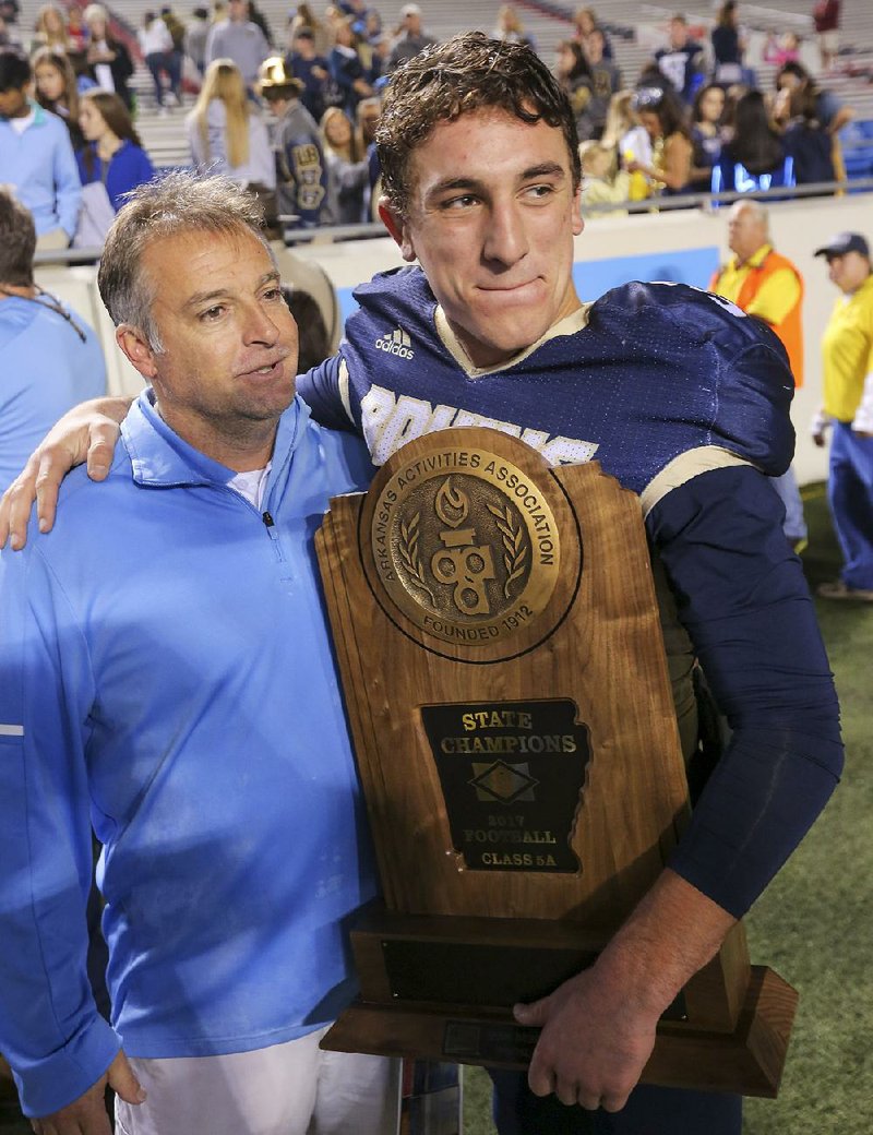 Pulaski Academy football coach Kevin Kelley and quarteback Layne Hatcher celebrate their 5A High School Football State Championship against McClellan.