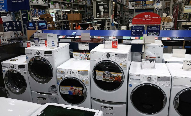 Washing machines are displayed at a Lowe’s store in East Rutherford, N.J. Durable-goods orders slipped 1.7 percent in April from March, the Commerce Department reported Friday.  