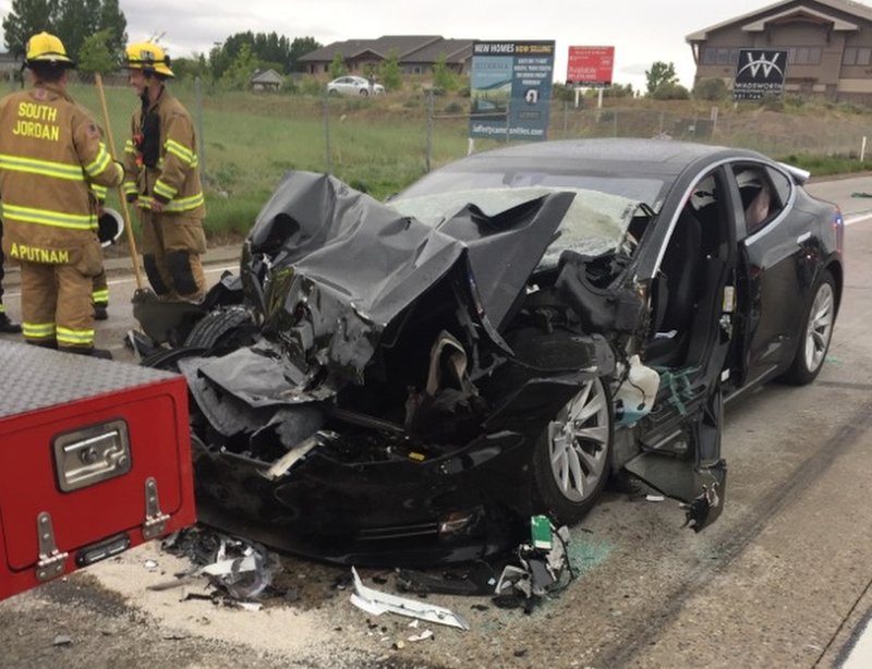 FILE - In this Friday, May 11, 2018, file photo released by the South Jordan Police Department shows a traffic collision involving a Tesla Model S sedan with a Fire Department mechanic truck stopped at a red light in South Jordan, Utah. The Tesla that crashed while in Autopilot mode accelerated in the seconds before it smashed into the stopped firetruck, according to a police report obtained by The Associated Press. Two people were injured. Data from the Model S electric vehicle show it picked up speed for 3.5 seconds before crashing into the firetruck the report said. The driver manually hit the brakes a fraction of a second before impact. (South Jordan Police Department via AP,File)