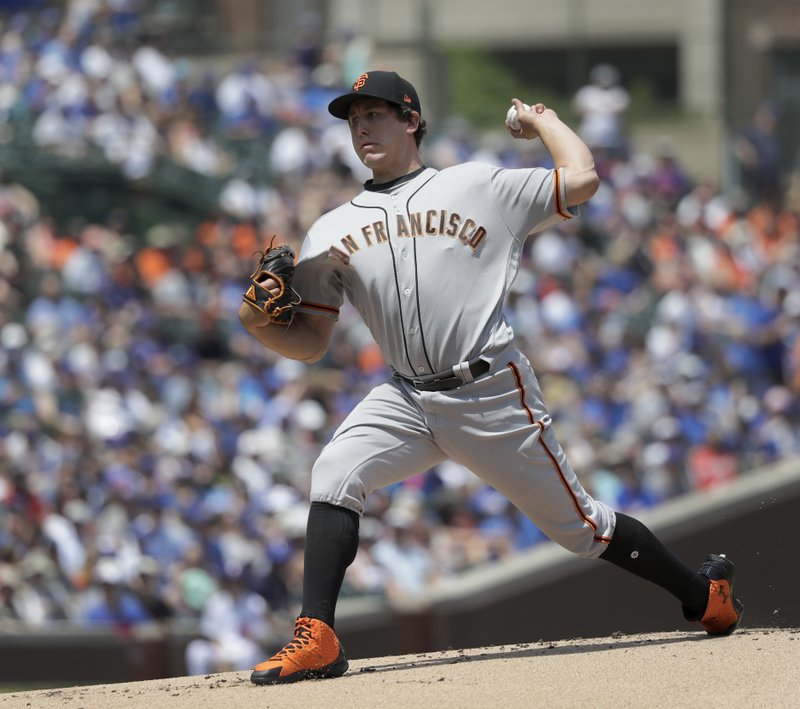 San Francisco Giants starting pitcher Derek Holland delivers during the first inning of a baseball game against the Chicago Cubs Friday, May 25, 2018, in Chicago. (AP Photo/Charles Rex Arbogast)