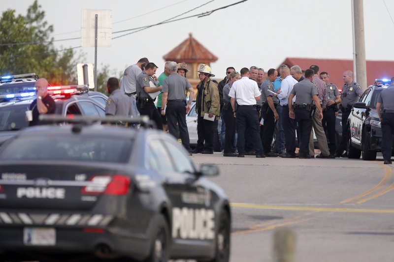 Police and emergency personnel surround the scene of a shooting at Lake Hefner in Oklahoma City, Thursday, May 24, 2018. A man armed with a pistol walked into Louie’s On The Lake restaurant at the dinner hour and opened fire, wounding two customers, before being shot dead by a handgun-carrying civilian in the parking lot, police said. (Bryan Terry/The Oklahoman via AP)