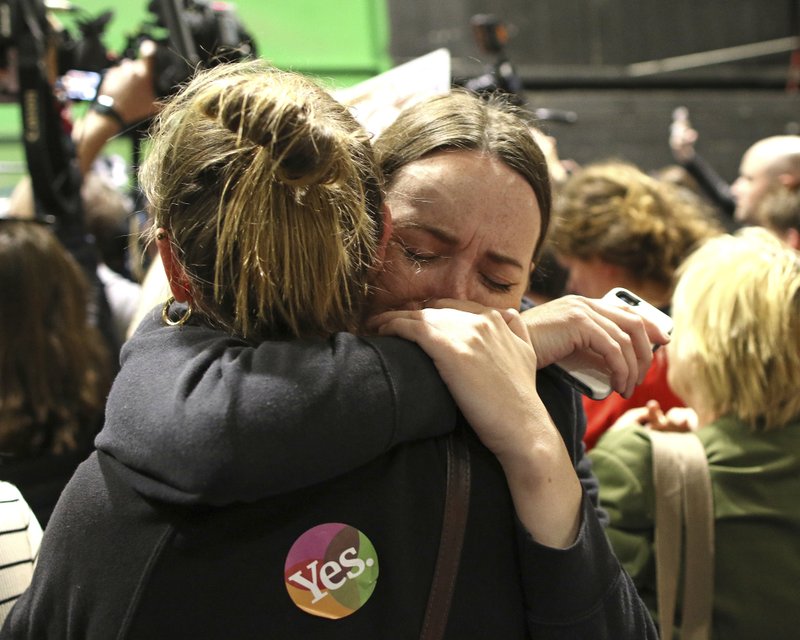 People from the"Yes" campaign react as the results of the votes begin to come in, after the Irish referendum on the 8th Amendment of the Irish Constitution at the RDS count centre, in Dublin, Ireland, Saturday May 26, 2018. A leading anti-abortion group says Ireland’s historic abortion referendum has resulted in a "tragedy of historic proportions" in a statement that all but admits defeat, as two exit polls predict an overwhelming victory for those seeking to overturn the country’s strict ban on terminations. (AP Photo/Peter Morrison)