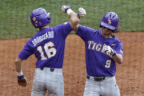 LSU's Zach Watson (9) celebrates with Brandt Broussard (16) after hitting a two-run home run during the sixth inning of a Southeastern Conference tournament NCAA college baseball game against Arkansas, Saturday, May 26, 2018, in Hoover, Ala. (AP Photo/Butch Dill)

