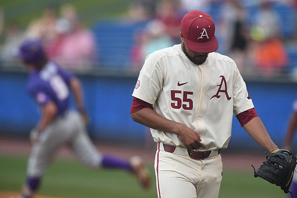 Arkansas pitcher Isaiah Campbell (55) looks down while LSU hitter Zach Watson rounds first base after Watson hit a home run during an SEC Tournament game Saturday, May 26, 2018, in Hoover, Ala. 