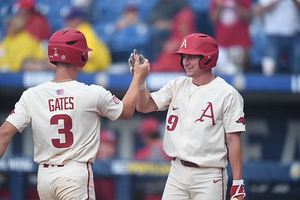 Arkansas shortstop Jax Biggers (9) greets first baseman Jared Gates (3) after Gates hit a home run during an SEC Tournament game against LSU on Saturday, May 26, 2018, in Hoover, Ala. 