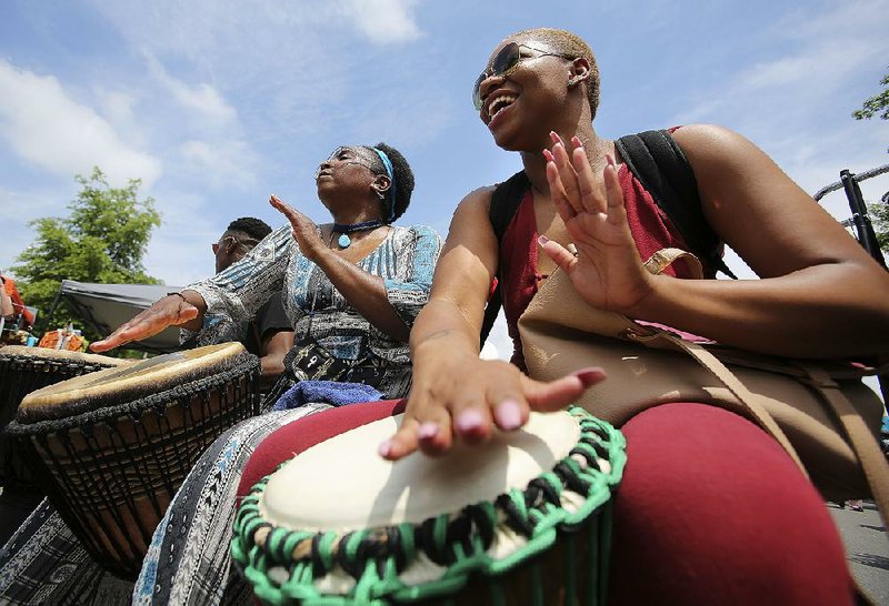 Denisha Cleaves (right) of Memphis and Shakeenah Kadem of Fort Smith perform Saturday during the second annual Africa Day Fest in Little Rock. More photos are available at arkansasonline.com/galleries. 