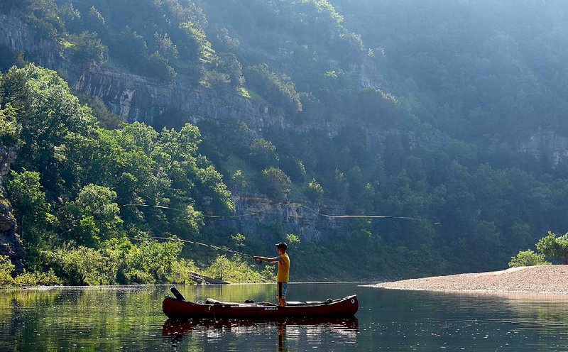 Matthew Eldridge of Dallas takes a turn with a fly rod Tuesday on the Buffalo River near Rush